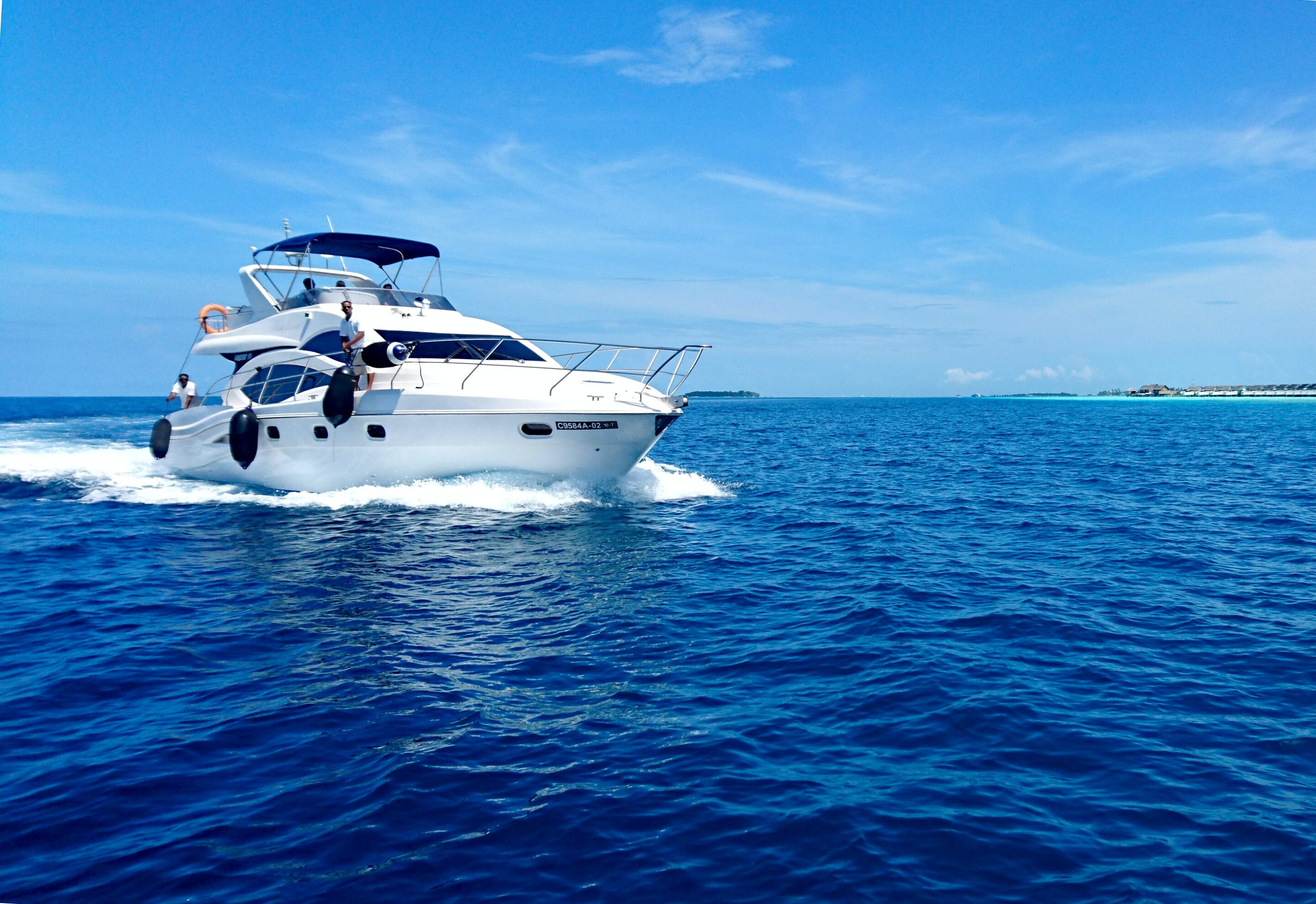 A yacht sailing in calm waters on a beautiful sunny day.