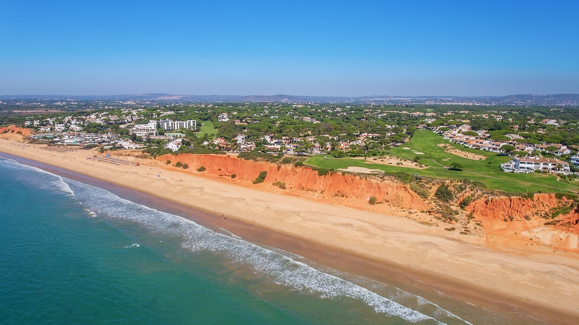 An aerial shot of the sea and sandy beaches in the Algarve, Portugal.