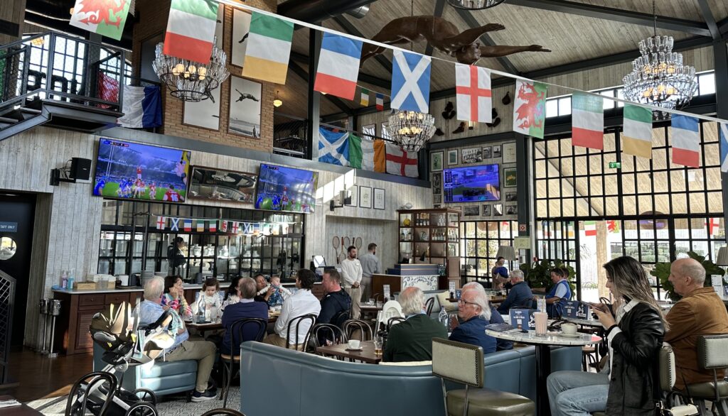 A busy bar with people watching sports